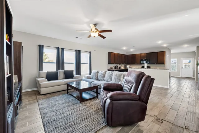a living room with furniture and wooden floor