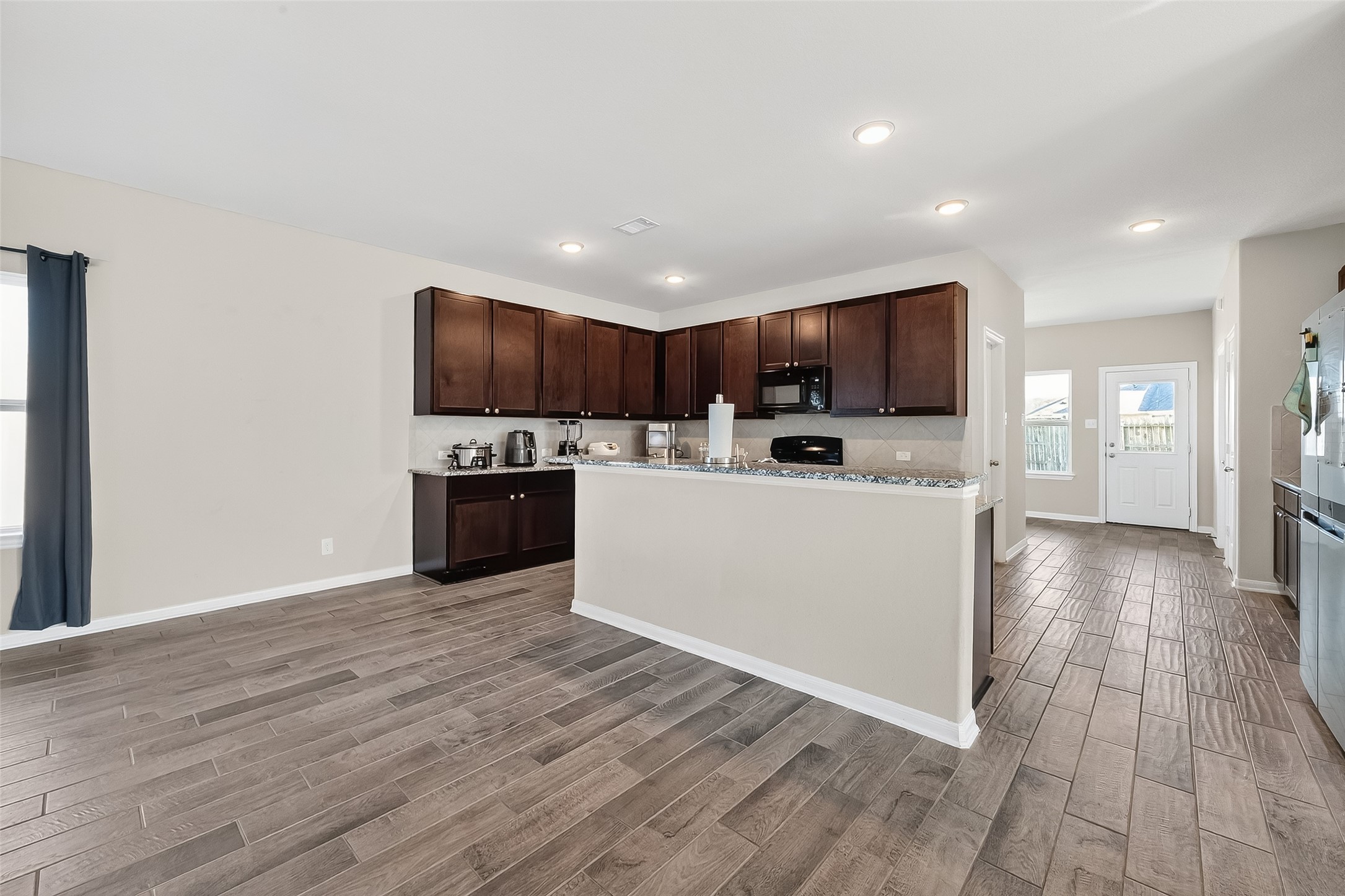2422 Agassiz Drive Rosharon, TX 77583 - Photo 8 of 41 a kitchen with stainless steel appliances a refrigerator sink and microwave