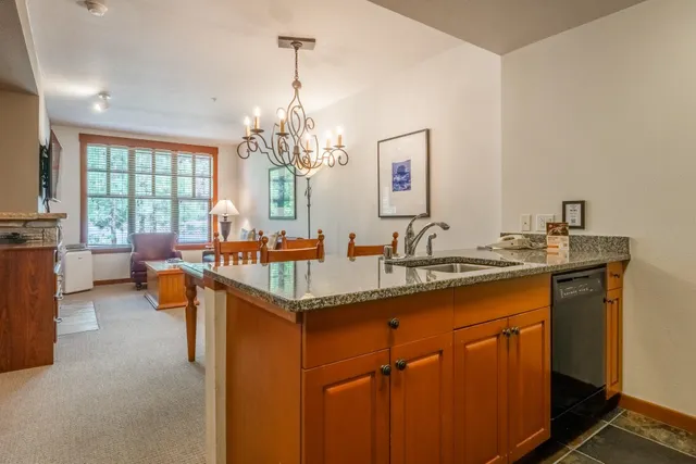 a view of living room with granite countertop furniture and a chandelier