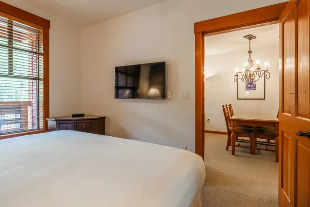 a bedroom with a bed and a table