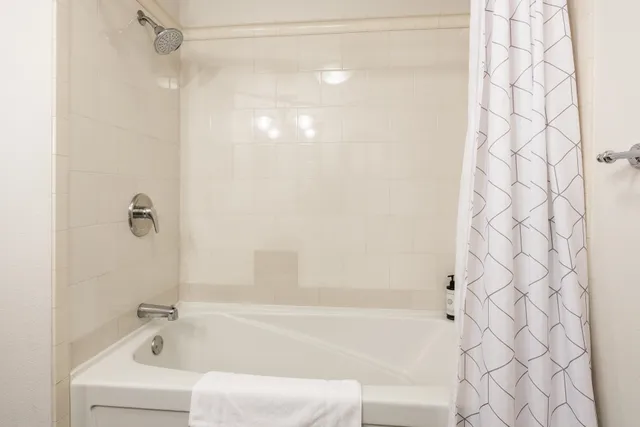a bathroom with a shower and a bath tub