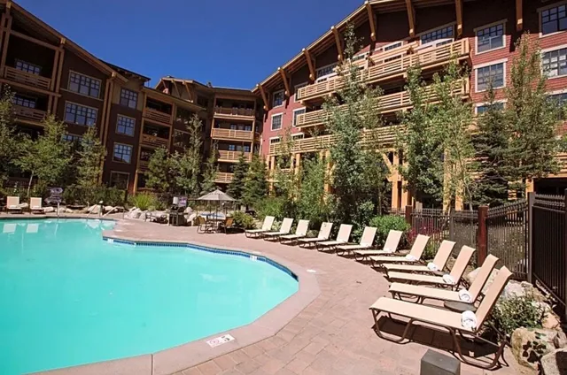 a view of swimming pool with outdoor seating and plants