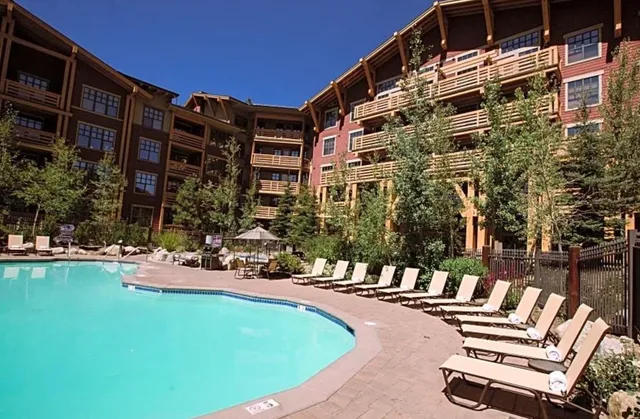 a view of a building with backyard and sitting area
