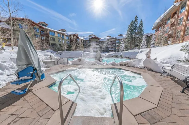 a view of swimming pool with outdoor seating and city view