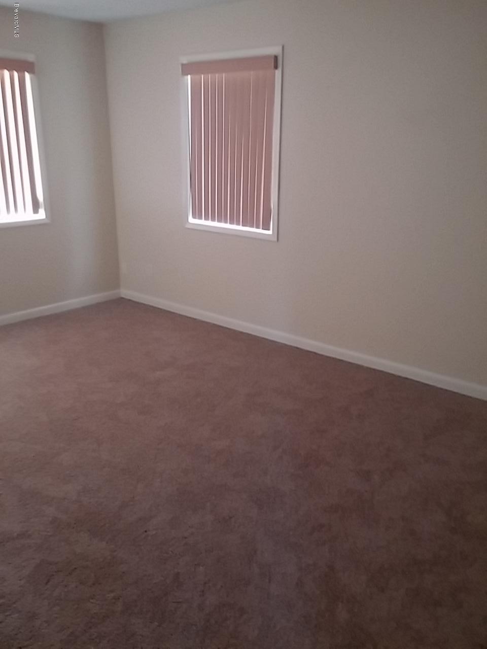 1645 Anson Road Melbourne, FL 32934 - Photo 7 of 21 an empty room with windows