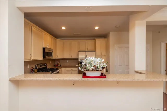 a kitchen with a refrigerator a sink and cabinets