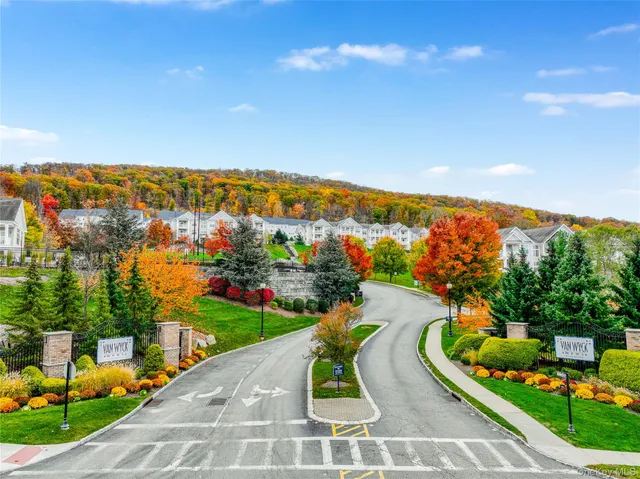 an aerial view of a house with a swimming pool and trees