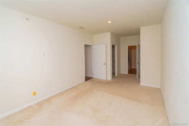 a bathroom with a granite countertop sink a toilet and a mirror
