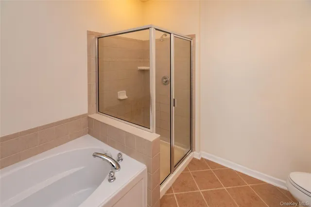 a bathroom with bathtub and shower