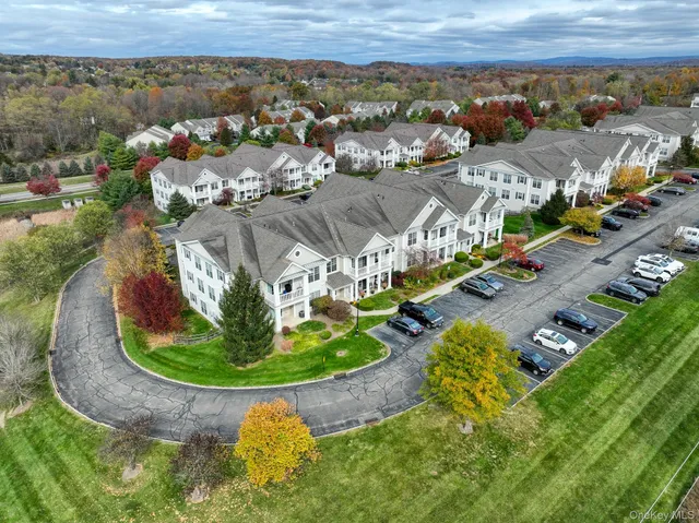 an aerial view of a house with a big yard