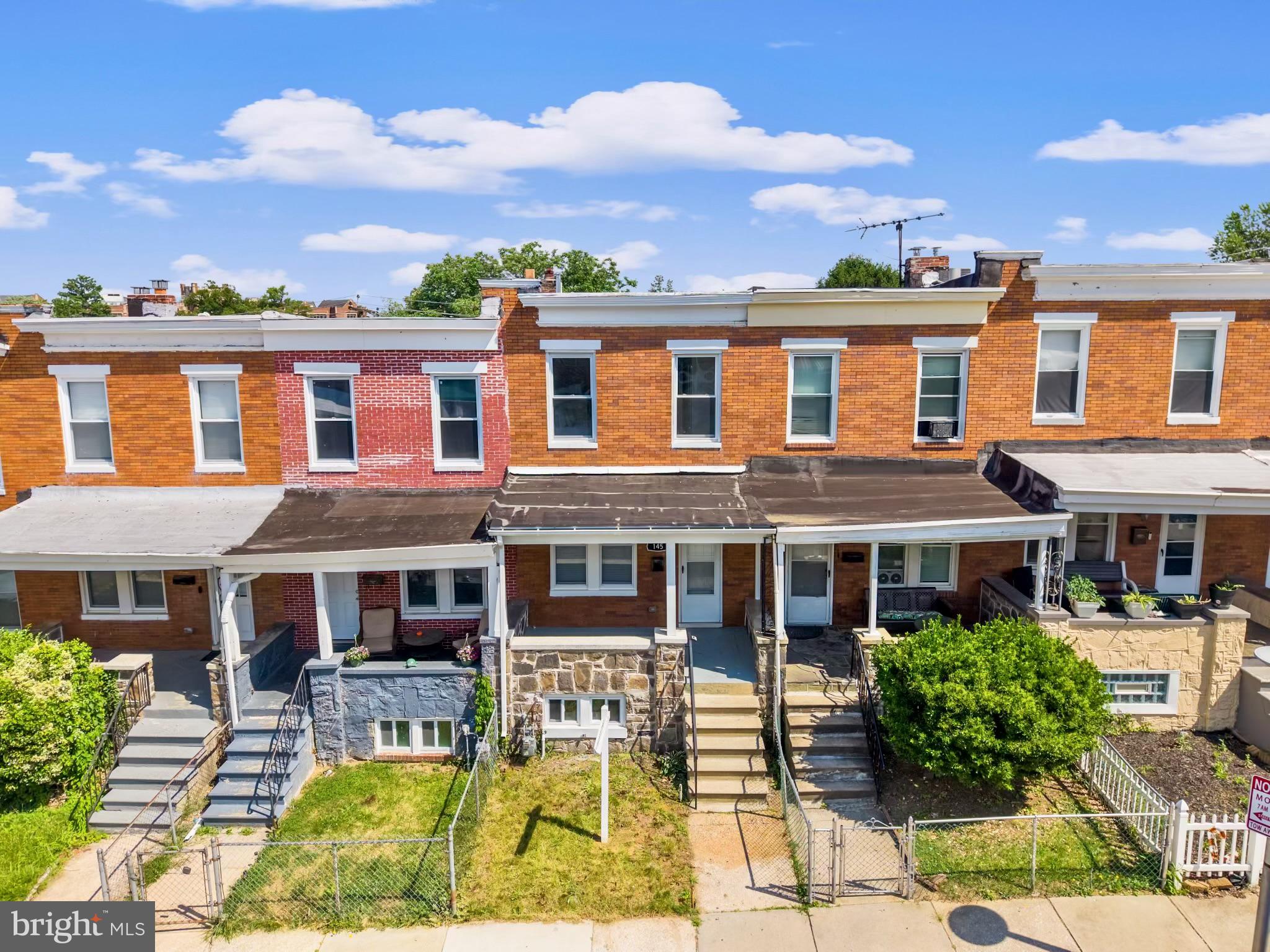 145 North Monastery Avenue Baltimore, MD 21229 - Photo 38 of 45 Charming row homes under blue skies.