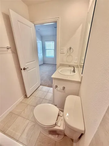 a white toilet sitting next to a bathroom sink