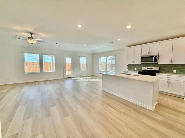a view of a kitchen with microwave and cabinets