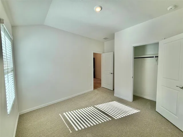a view of a room with wooden floor and windows