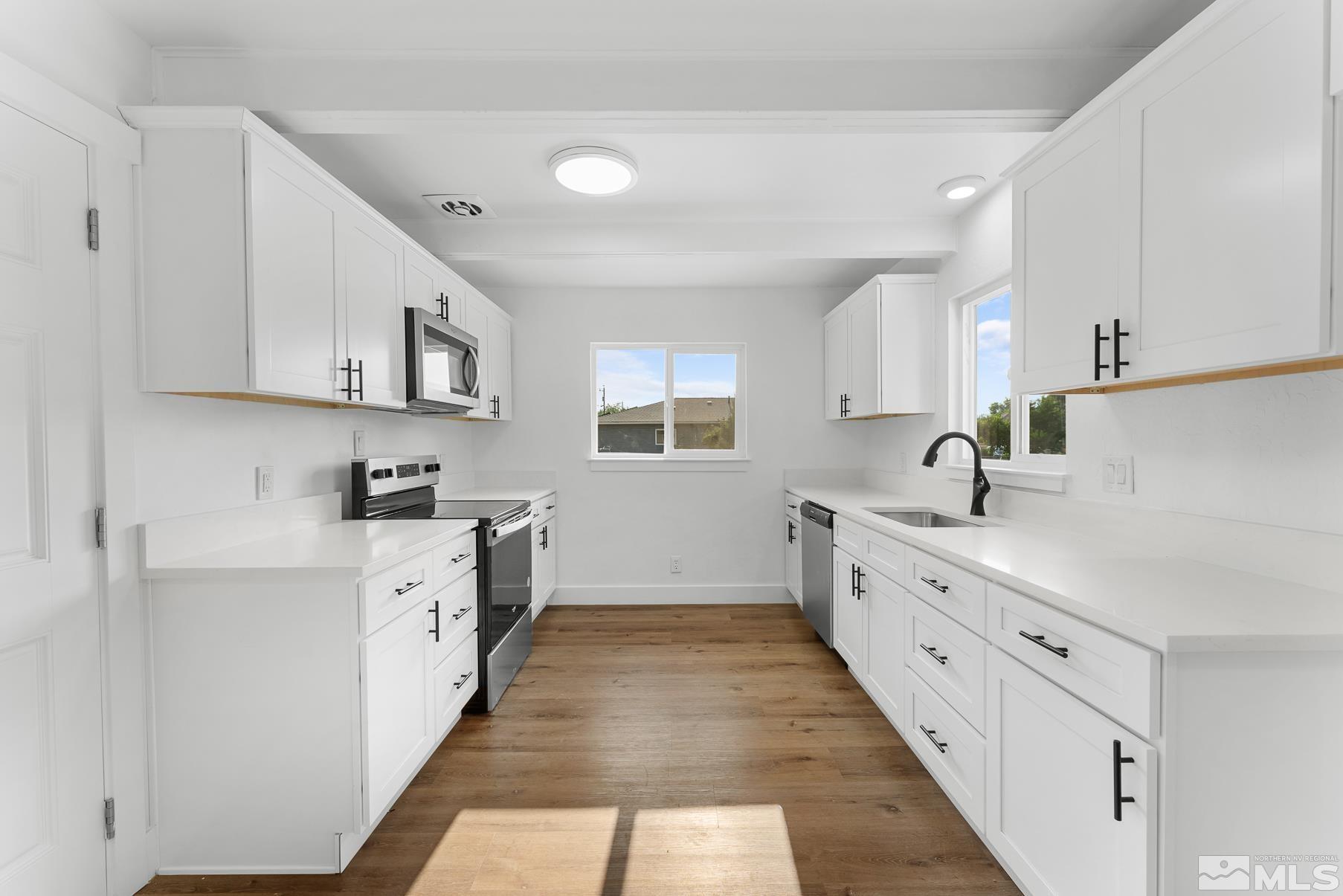 1350 Manhattan Street Reno, NV 89512 - Photo 2 of 18 a kitchen with sink cabinets and window