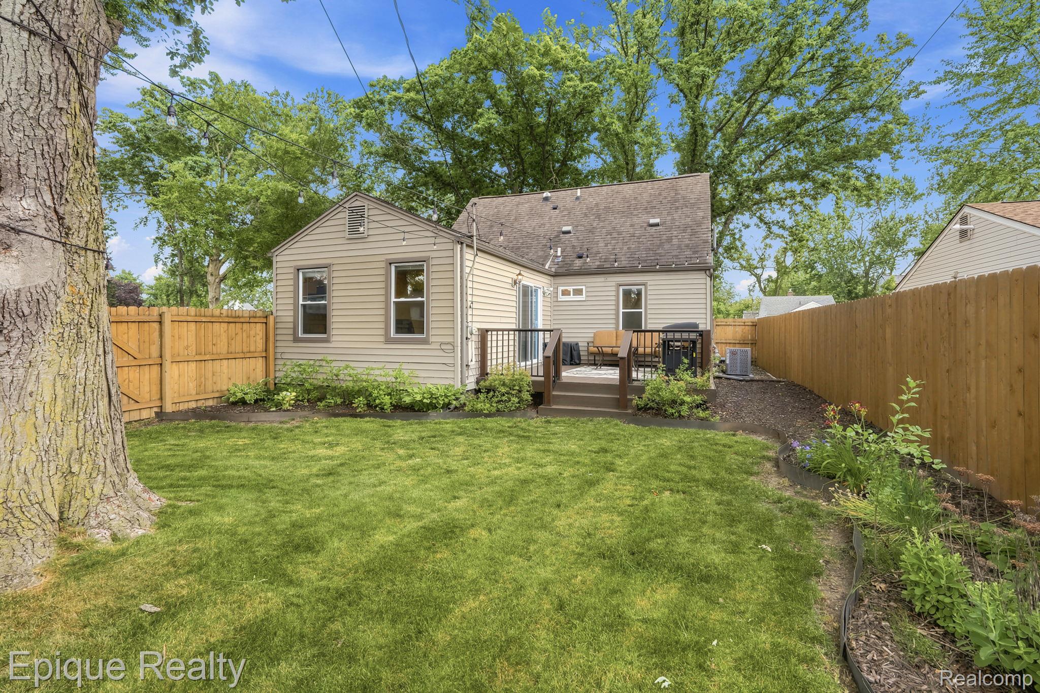 3402 Normandy Road Royal Oak, MI 48073 - Photo 24 of 32 Expansive fenced backyard featuring a manicured lawn, established landscaping, and a low maintenance Trex deck