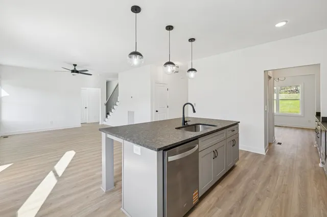 a kitchen with a stove and a wooden floor