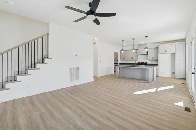 a view of kitchen with wooden floor electronic appliances and window