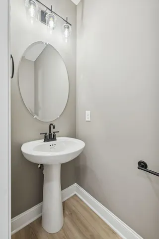 a bathroom with a sink a mirror and vanity