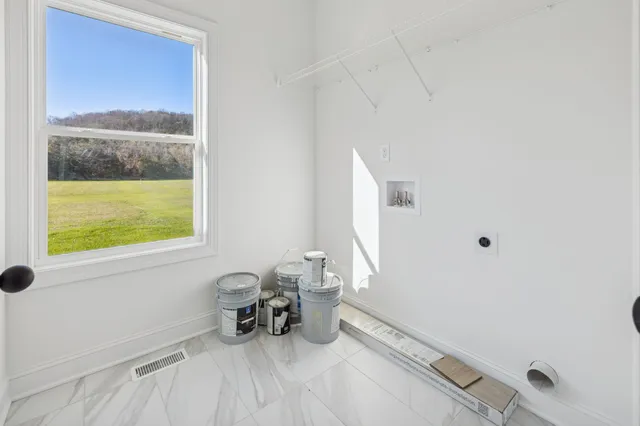 a view of a room that has a bed and a window