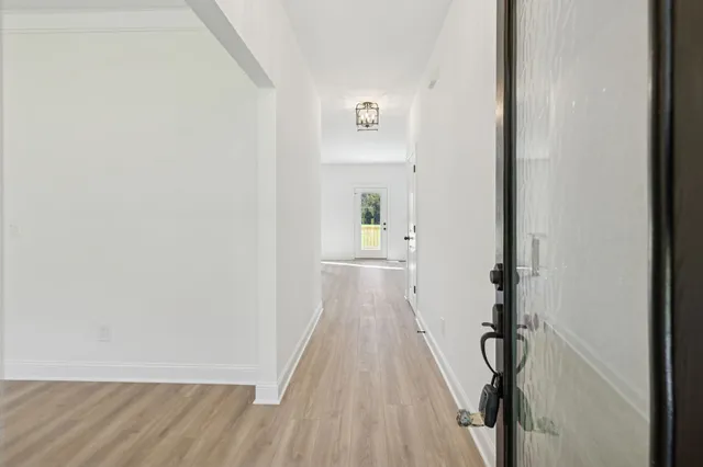a view of a room with wooden floor