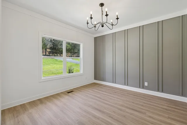 a view of a livingroom with wooden floor and windows