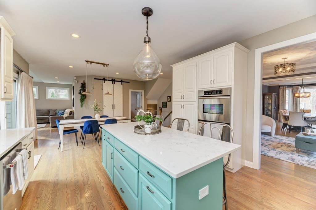 1061 Sean Circle Darien, IL 60561 - Photo 11 of 50 a view of a kitchen with kitchen island stainless steel appliances a dining table and chairs