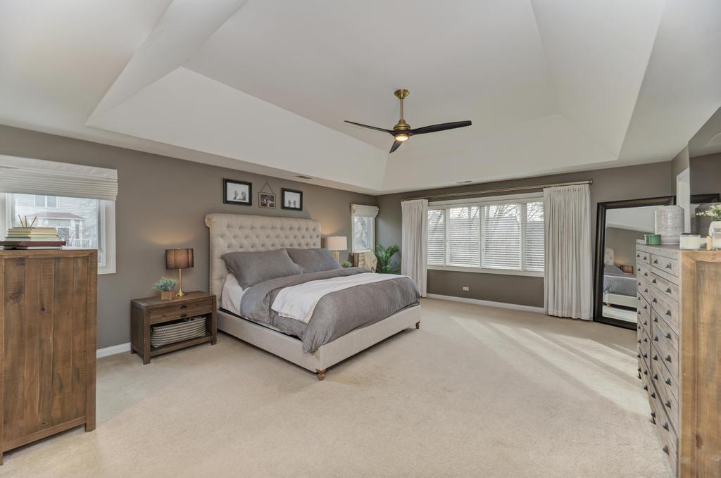 1061 Sean Circle Darien, IL 60561 - Photo 20 of 50 a bedroom with a large bed and a tv