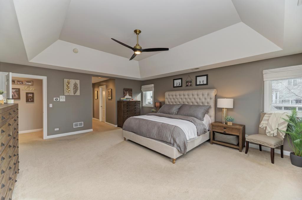 1061 Sean Circle Darien, IL 60561 - Photo 21 of 50 a bedroom with a large bed couch and window