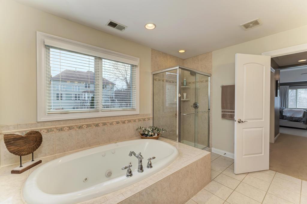 1061 Sean Circle Darien, IL 60561 - Photo 23 of 50 a bathroom with a bathtub and a shower