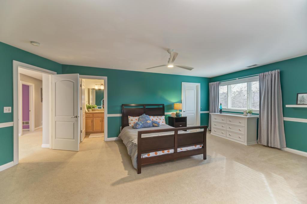 1061 Sean Circle Darien, IL 60561 - Photo 24 of 50 a bedroom with a bed and a large window
