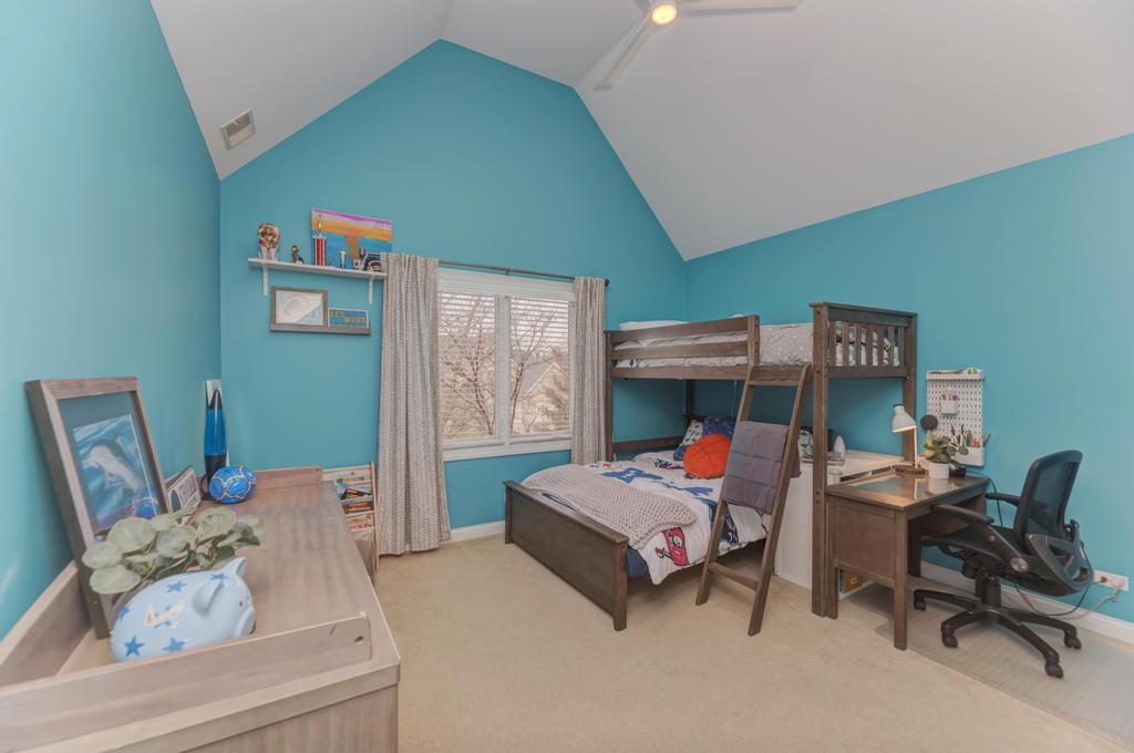 1061 Sean Circle Darien, IL 60561 - Photo 27 of 50 a bedroom with a bed and a chair