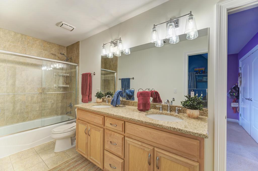 1061 Sean Circle Darien, IL 60561 - Photo 29 of 50 a bathroom with a granite countertop sink a toilet a mirror a vanity and shower