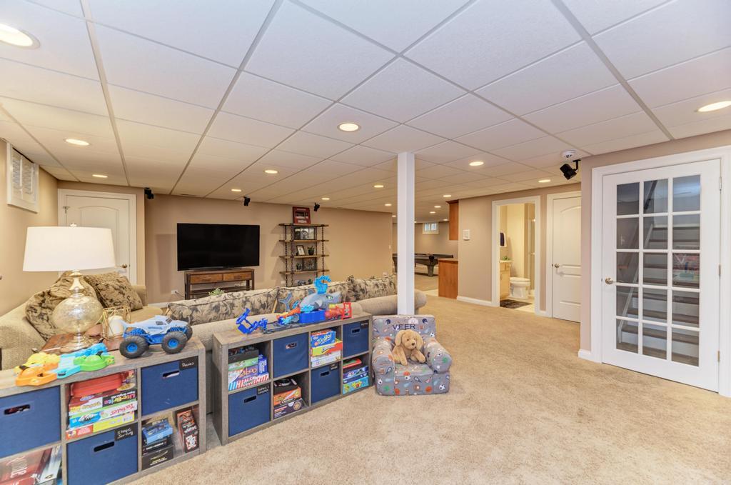1061 Sean Circle Darien, IL 60561 - Photo 32 of 50 a playing room with furniture and a flat screen tv