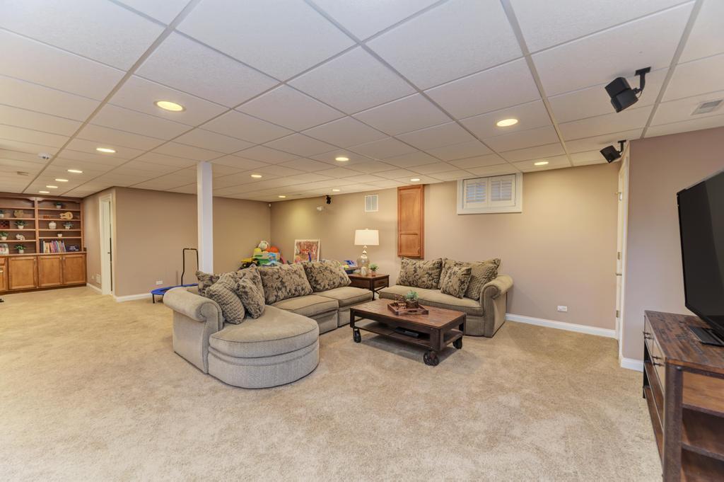1061 Sean Circle Darien, IL 60561 - Photo 34 of 50 a living room with furniture and a flat screen tv