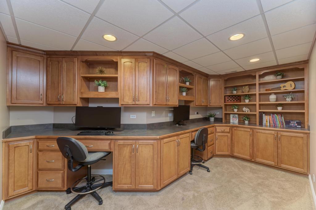1061 Sean Circle Darien, IL 60561 - Photo 35 of 50 a kitchen with stainless steel appliances granite countertop a stove sink and cabinets