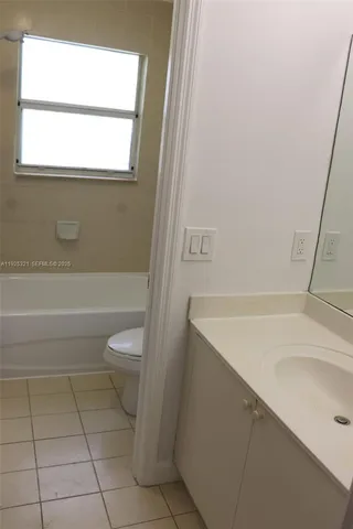 a bathroom with a toilet and a bath tub