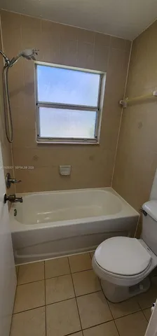 a bathroom with a toilet and a bathtub