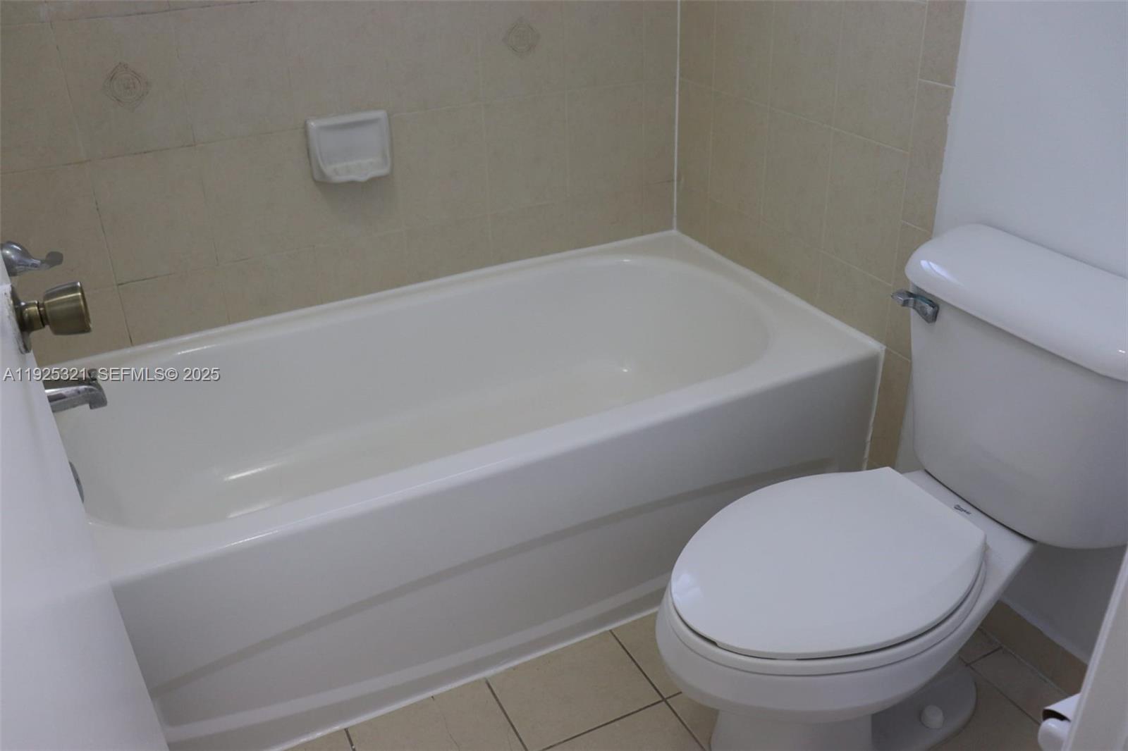 2940 Southeast 15th Terrace, Unit 2940 Homestead, FL 33035 - Photo 16 of 28 a bathroom with a toilet and a bathtub
