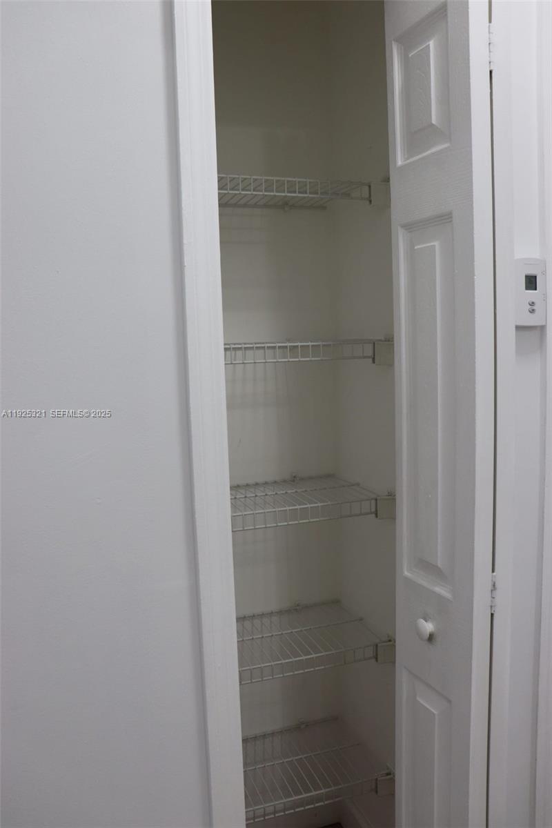 2940 Southeast 15th Terrace, Unit 2940 Homestead, FL 33035 - Photo 17 of 28 a bathroom with a glass shower door