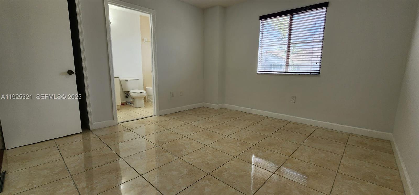 2940 Southeast 15th Terrace, Unit 2940 Homestead, FL 33035 - Photo 18 of 28 an empty room with windows