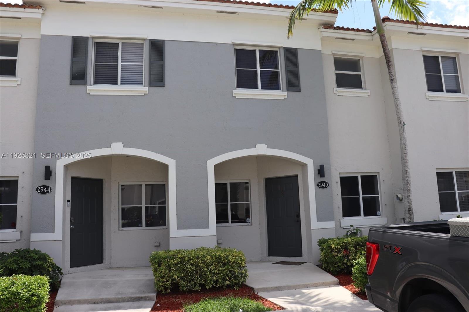 2940 Southeast 15th Terrace, Unit 2940 Homestead, FL 33035 - Photo 25 of 28 a front view of a house with a garden