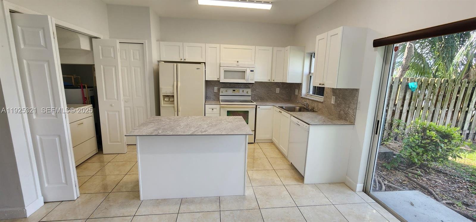 2940 Southeast 15th Terrace, Unit 2940 Homestead, FL 33035 - Photo 7 of 28 a kitchen with stainless steel appliances granite countertop a refrigerator and a sink