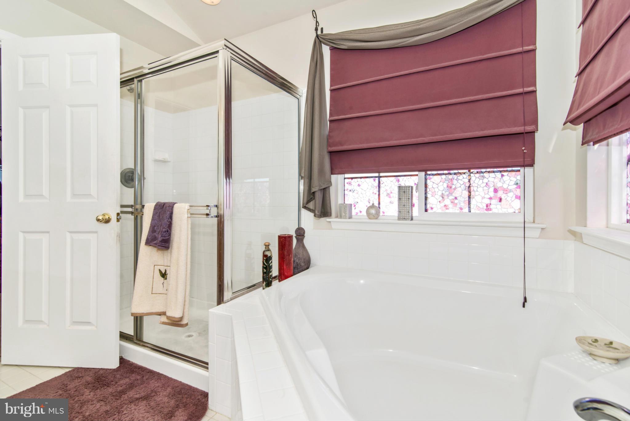 14625 Bubbling Spring Road Boyds, MD 20841 - Photo 18 of 30 a bathroom with a bathtub and a shower