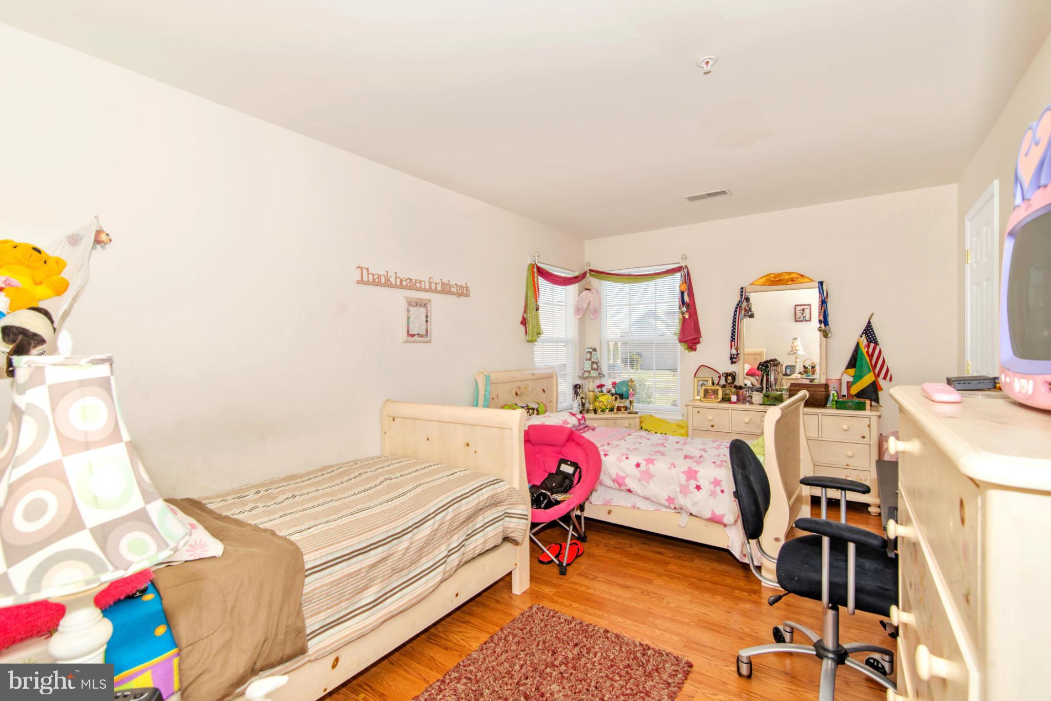 14625 Bubbling Spring Road Boyds, MD 20841 - Photo 19 of 30 a bedroom with a bed and a chandelier