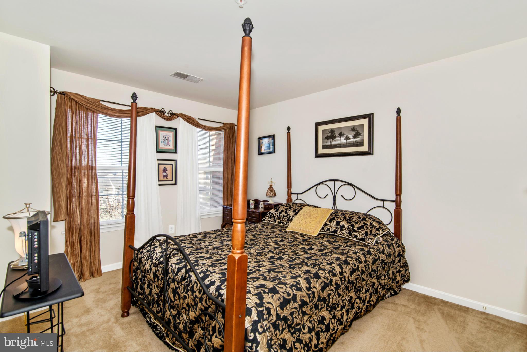 14625 Bubbling Spring Road Boyds, MD 20841 - Photo 22 of 30 a bedroom with a bed next to a window with the outer view