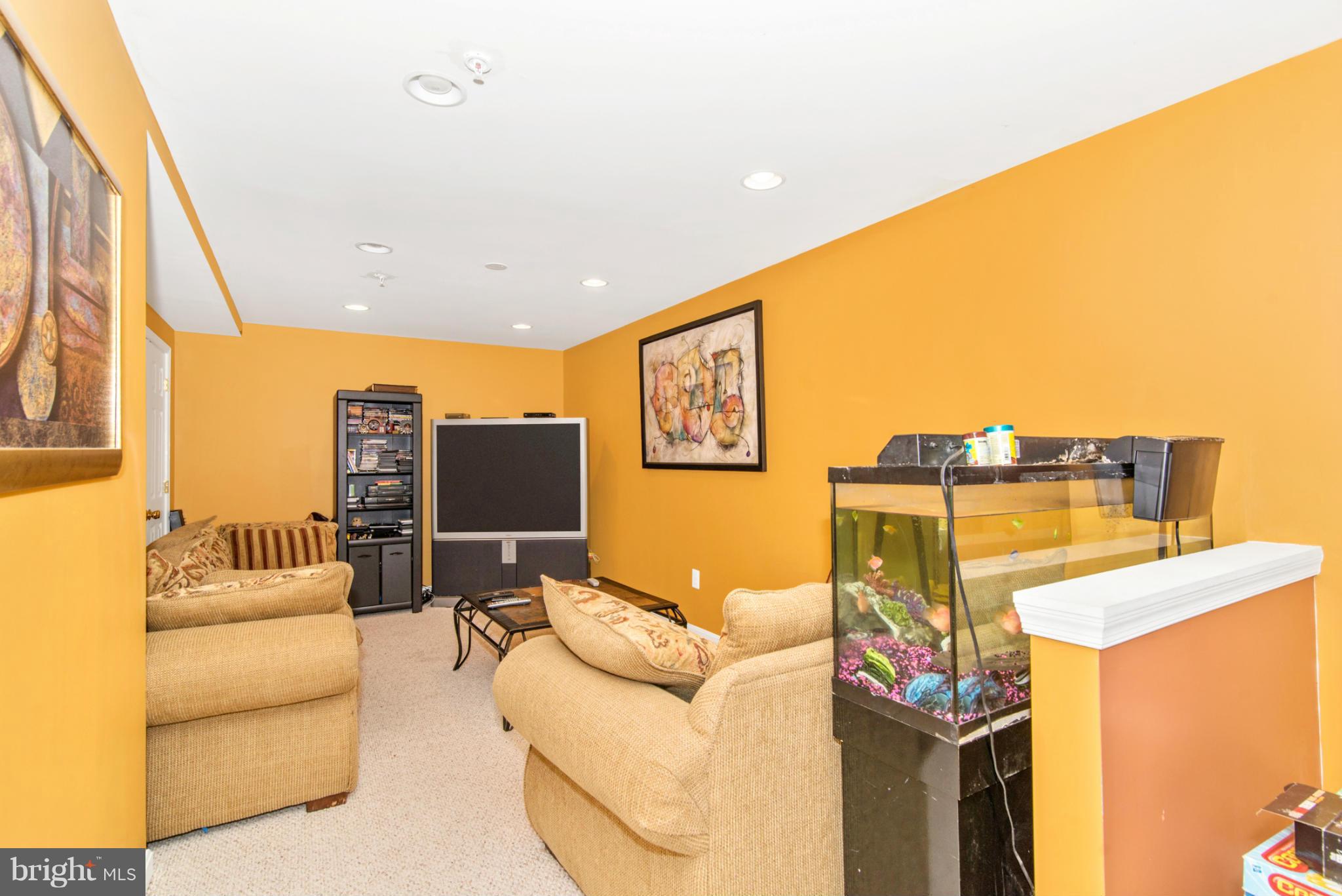 14625 Bubbling Spring Road Boyds, MD 20841 - Photo 27 of 30 a living room with furniture and a flat screen tv