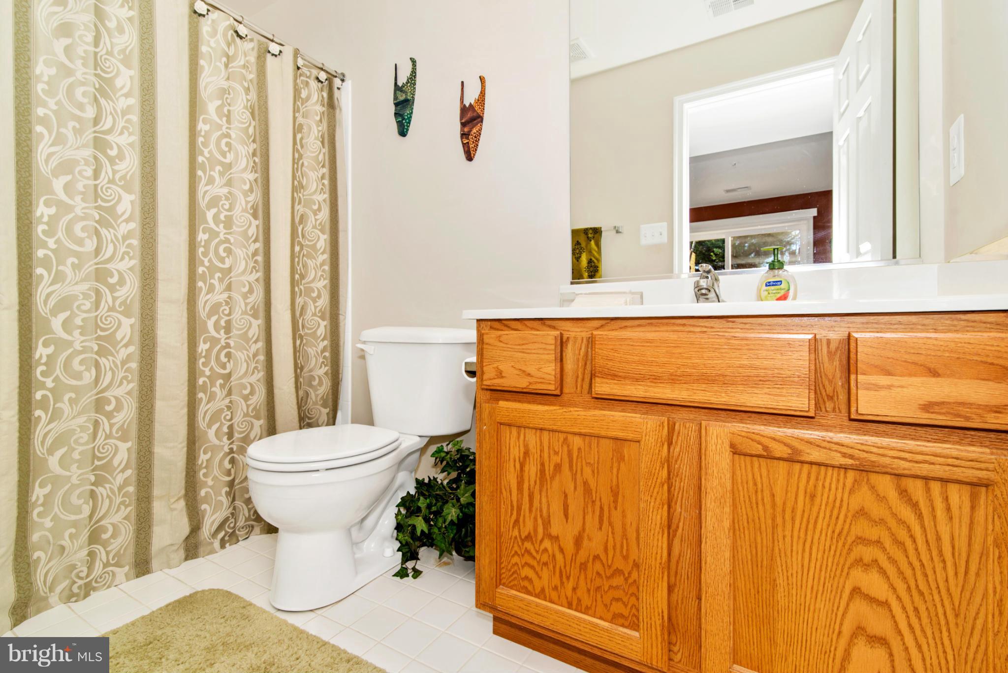 14625 Bubbling Spring Road Boyds, MD 20841 - Photo 29 of 30 a bathroom with a sink a toilet and a mirror