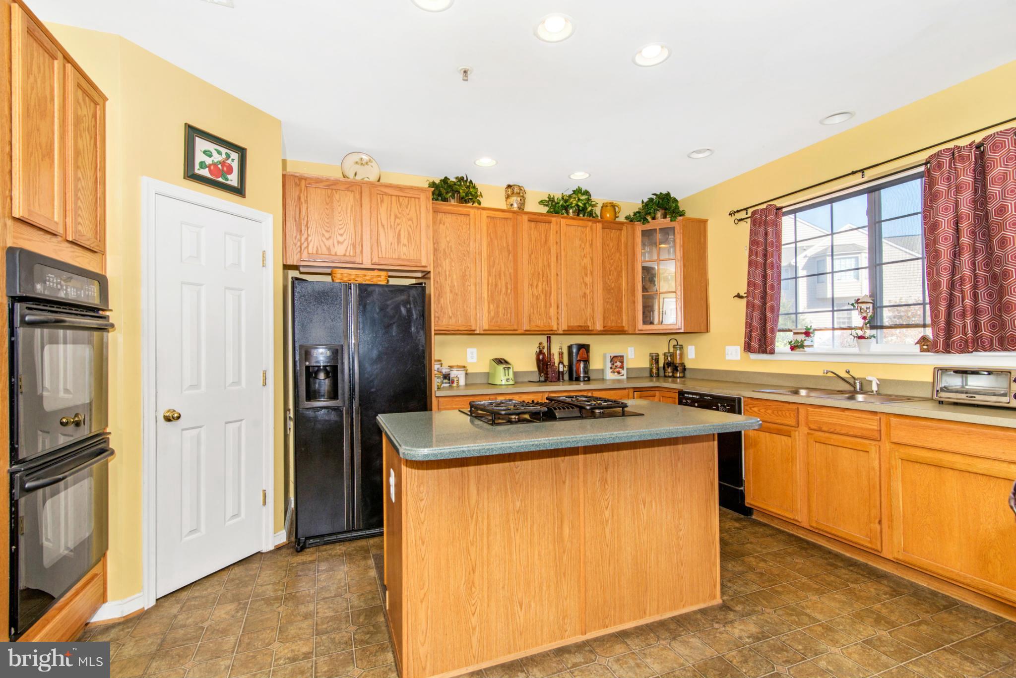 14625 Bubbling Spring Road Boyds, MD 20841 - Photo 7 of 30 a kitchen with stainless steel appliances granite countertop a stove a refrigerator and a sink