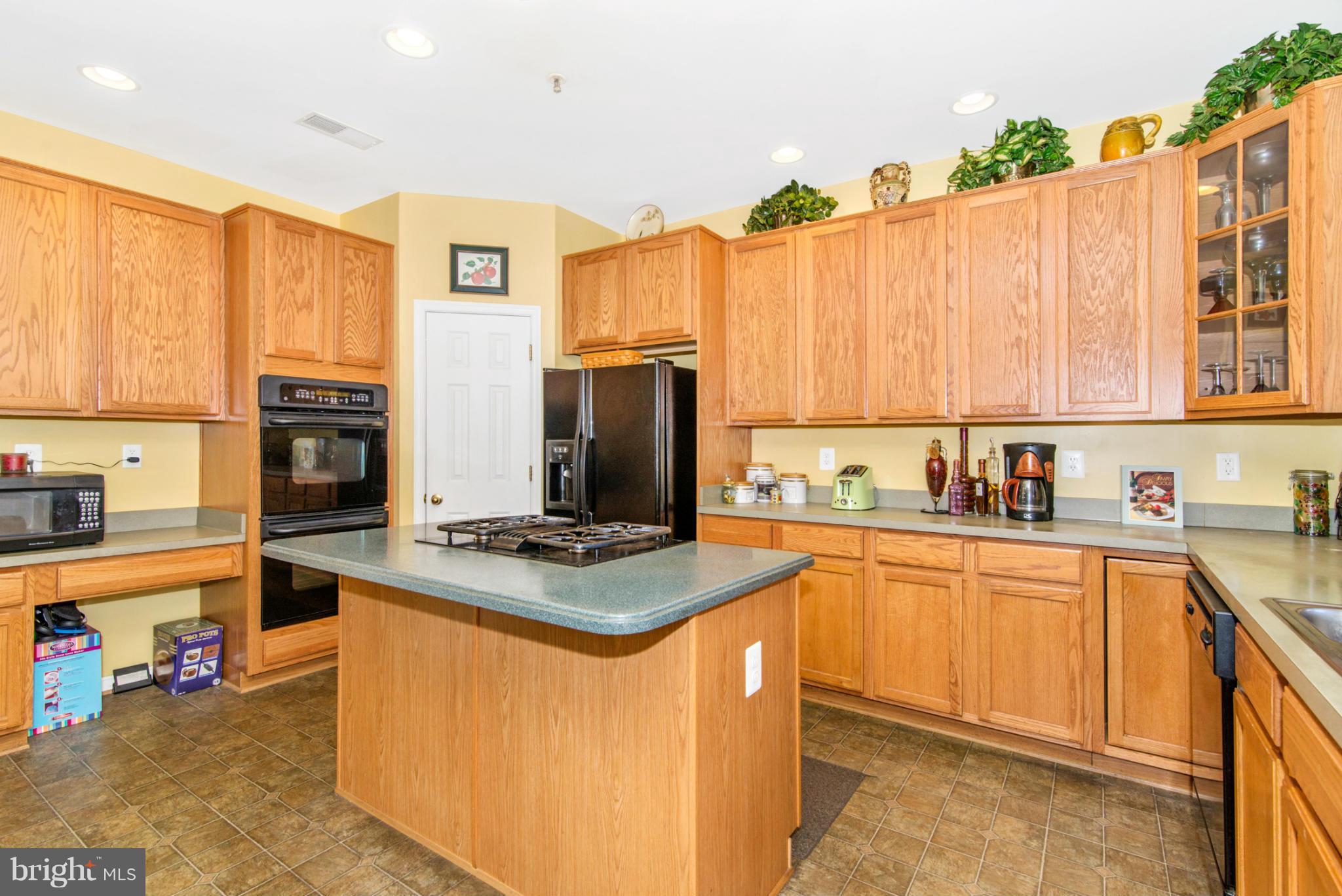 14625 Bubbling Spring Road Boyds, MD 20841 - Photo 9 of 30 a kitchen with stainless steel appliances granite countertop a stove refrigerator sink and cabinets